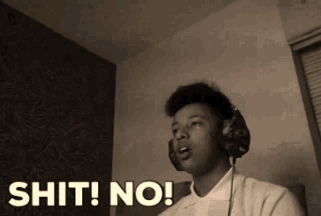 a man wearing headphones says shit no in a black and white photo