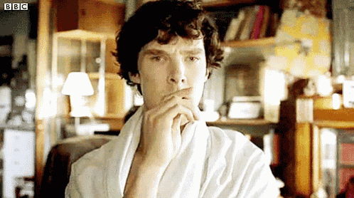 a man in a white robe is sitting in a chair .