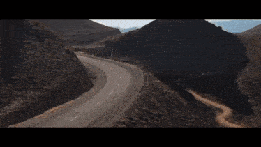 a car is driving down a desert road
