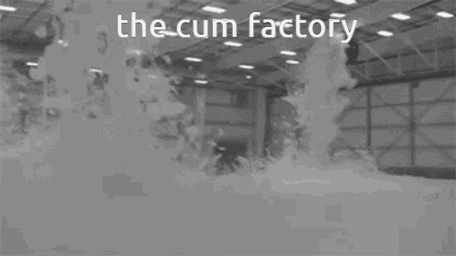 a black and white photo of a factory with the words " the cum factory " on the bottom