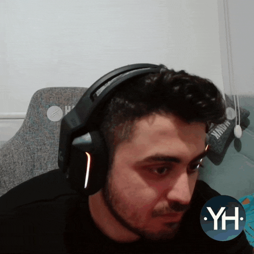 a man wearing headphones with the letters yh on the bottom right