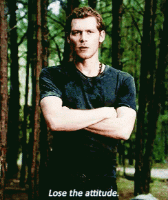 a man stands in the woods with his arms crossed and the words lose the attitude written below him