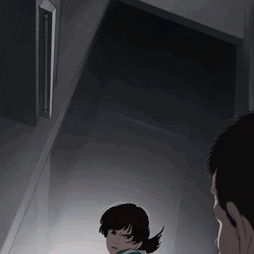 a man looks at a girl in a dark room