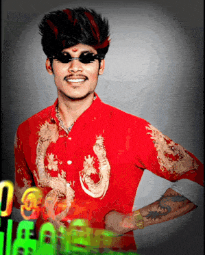 a man wearing a red shirt with dragons on the sleeves