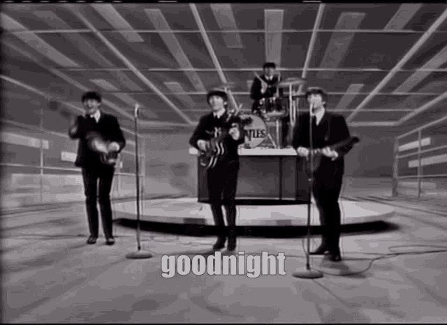 a black and white photo of the beatles with the words goodnight in the corner