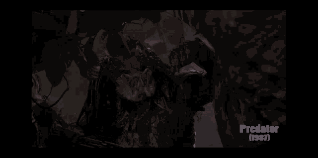 a predator from the movie predator 1987 is standing next to a tree