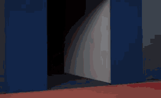 mario is walking through a doorway in a video game .