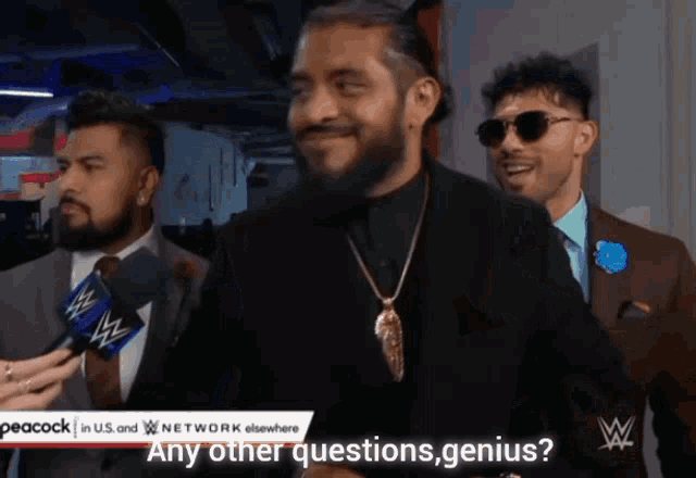 a man talking into a microphone with the words any other questions genius on the screen