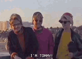a group of people are standing next to each other and one of them says i 'm tommy .