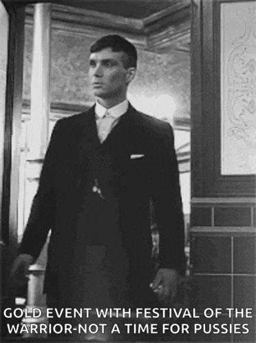 a black and white photo of a man in a suit and tie