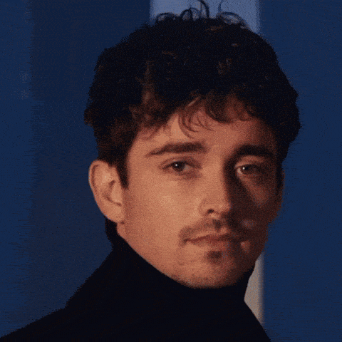 a close up of a man 's face with a turtleneck on