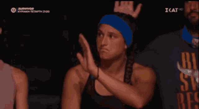 a woman wearing a blue headband and a black shirt that says rescue on it