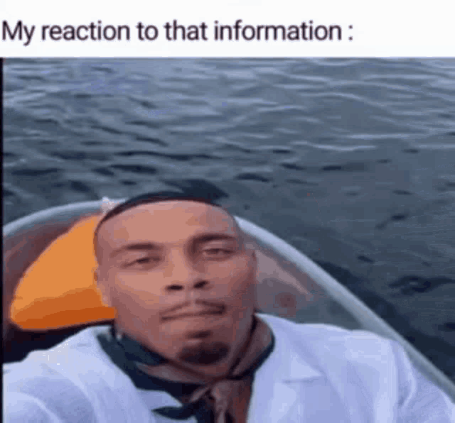 a man in a white coat and tie is taking a selfie in a boat in the water .