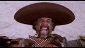 a man wearing a sombrero and holding a gun with his mouth open