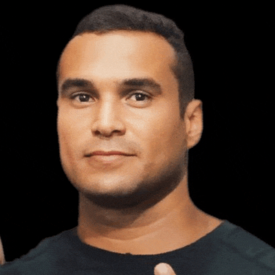 a man in a black shirt is giving a thumbs up sign .