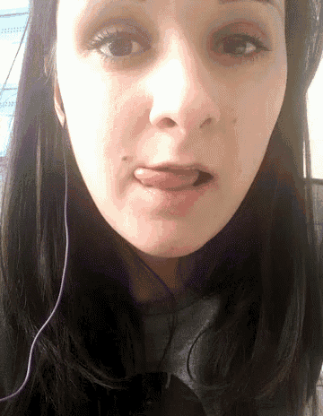a close up of a woman with her tongue out
