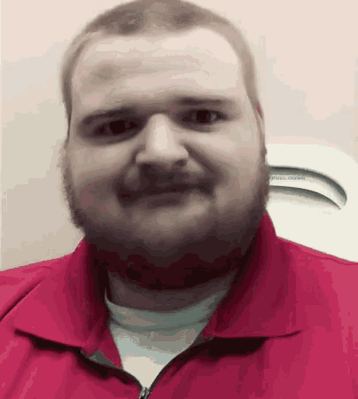 a man with a beard wears a red shirt with the word pull down on it