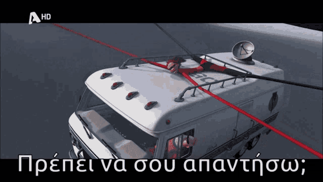 a cartoon of a man hanging from the roof of a truck with the letters ahd above it