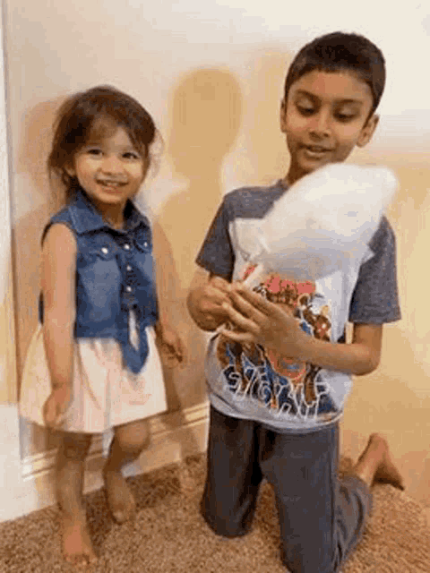 a boy and a girl are playing with cotton candy together .