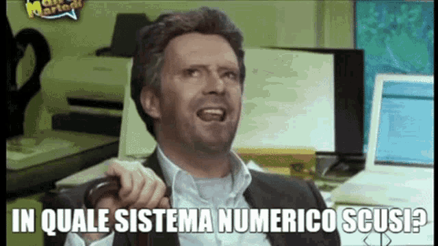 a man sitting at a desk with the words in quale sistema numerico scusi