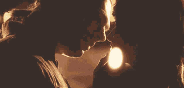a man and woman are kissing in the dark