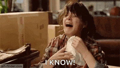a woman is laughing and crying while holding a napkin to her chest and saying `` i know '' .