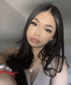 a woman with long black hair is wearing a necklace and a bracelet