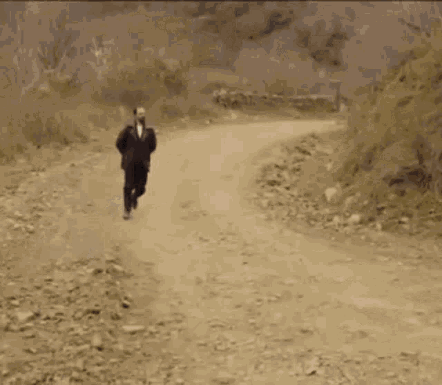 a man with a beard is wearing a black coat