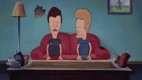 two cartoon characters , beavis and butthead , are sitting on a red couch in a living room .