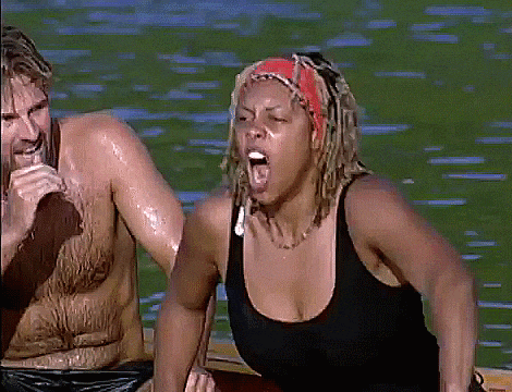 a man and a woman are in a canoe with the woman yawning