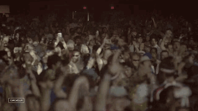 a large crowd of people at a concert with the word coachella on the bottom