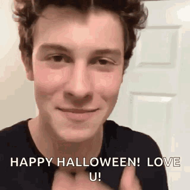 a young man is giving a thumbs up and saying `` happy halloween ! love u '' .