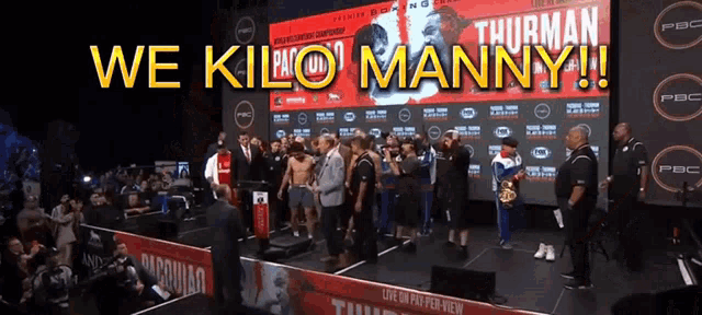 a group of people standing in front of a sign that says thurman manny