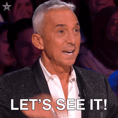 a man in a tuxedo says let 's see it in front of a crowd
