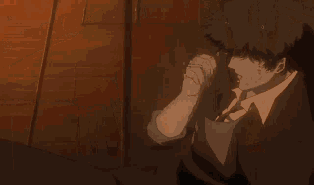 a person holding a gun in a dark room with a red background
