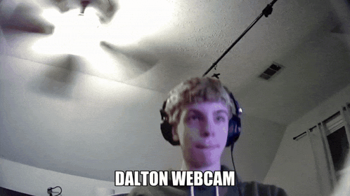 a young man wearing headphones looks at the camera with the words dalton webcam below him