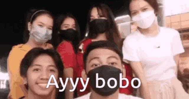 a group of people wearing face masks are standing next to each other .