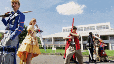 a group of people standing in front of a building with swords