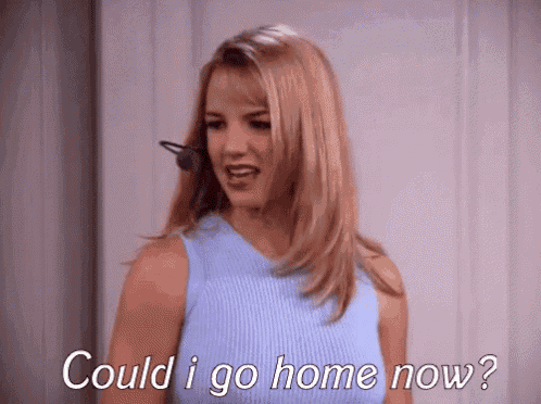 britney spears is wearing a headset and talking on a cell phone .