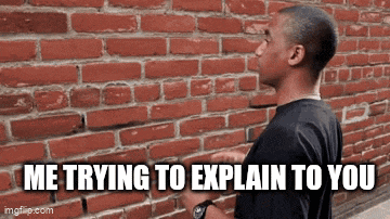 a man is standing in front of a brick wall .