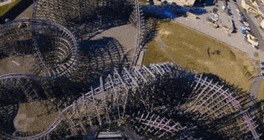 an aerial view of a roller coaster with a purple track