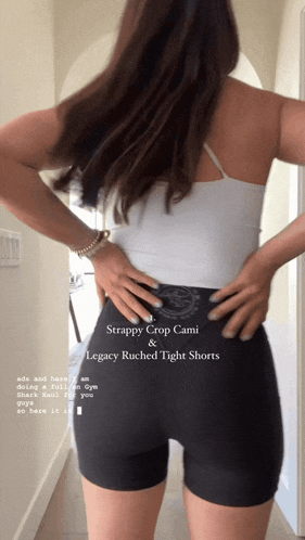 a woman wearing a strappy crop cami and legacy ruched tight shorts