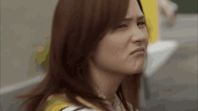 a woman with red hair is making a funny face .