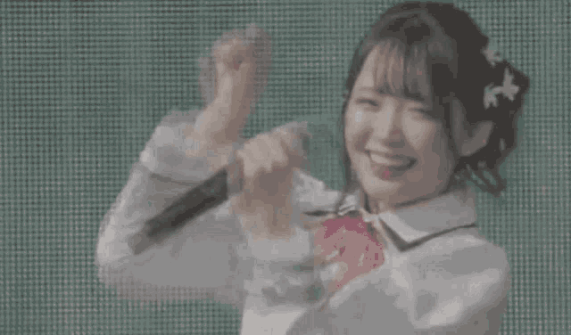 a girl is holding a microphone and smiling .