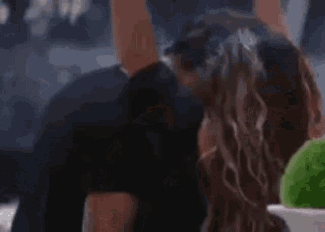 a man and a woman are kissing each other in a room .