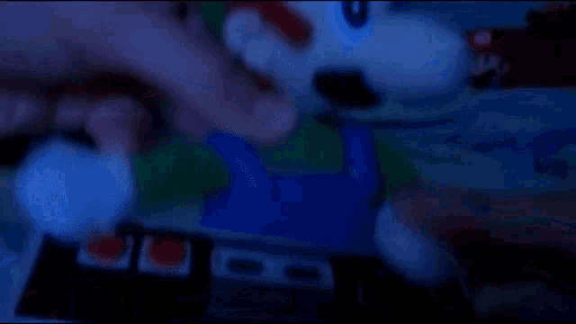 a blurred image of a person playing a video game with a remote control