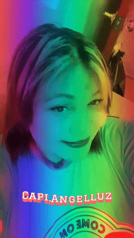 a girl with rainbow hair is wearing a shirt that says caplangelluz