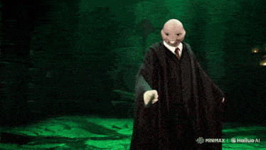 a man in a black robe is holding a green light