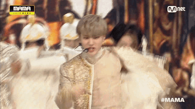 a man is dancing on a stage in front of a sign that says mama on it