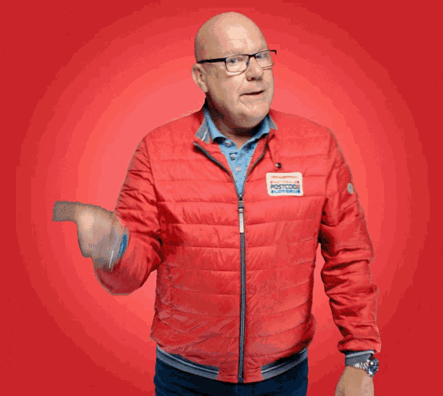 a man wearing a red jacket with a sticker on it that says ' amsterdam '